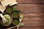 Bowl of Green Powder on Brown Wooden Surface