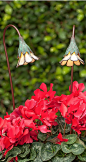 Our handmade Buttercup with Opal Glass Garden Light serves as elegant landscape art during the daytime, and functional garden lighting at night.