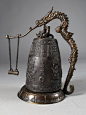 A Chinese bronze bell on stand with Gong.  The bell is finely molded with dragons and nymphs with one line inscription with original dragon shape stand and gong. Height: 11.5, circa 20th century.