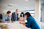 Photograph Architects drafting blueprints in office by Hero Images  on 500px