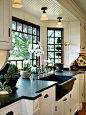 Especially love the windows in this kitchen (which I think I've pinned before) but also really love the dark counters against the white cabinetry: 