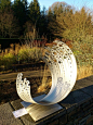 Winter sculpture exhibition at RHS Rosemoor, Devon. Wave in metal.