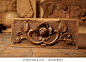 Wood carving. An ancient floral pattern carved on a wood background close up macro