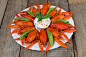 Plate with red boiled crayfish and herbs with white sauce on the side on a wooden table, background  by Alexander Volkov on 500px