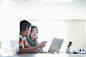 Students using laptops in classroom at college campus by Hero Images  on 500px