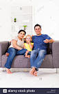 happy-young-family-watching-tv-on-sofa-at-home-D8RJ1N.jpg (866×1390)