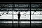 silhouette of man standing between two posts