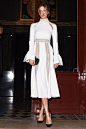 Karlie Kloss rocks a turtle-neck and fluttery sleeves in an elegant white maxi dress.: 