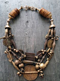 by Anna Holland | Necklace; three strands of antique brass beads, pendants, and talismans created by Akan craftsmen of the Baule tribe of the Ivory Coast, using the lost wax casting method.These are combined with rare ochre-colored antique vulcanite heish