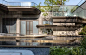 This may contain: an outdoor fountain in front of a building with glass balconies on the roof