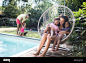 Happy mother and daughters cuddling in summer patio swing chair Stock Photo - Alamy : Download this stock image: Happy mother and daughters cuddling in summer patio swing chair - 2DG8KG6 from Alamy's library of millions of high resolution stock photos, il