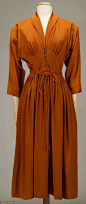 McCARDELL BURNT ORANGE SILK DRESS, 1949 V neck, long dolman sleeves, CF brass hook closures, self-fabric cord-tie belt