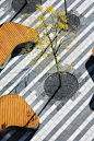 Geometric paving patterns mixed with organic street furniture