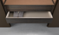 suspended drawer unit in coal larch and top in castoro regenerated leather fi nishing.