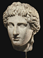A ROMAN MARBLE HEAD OF APOLLO CIRCA 1ST-2ND CENTURY A.D.