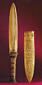 Gold dagger, from the tomb of King Tutankhamun, Carter # 256dd; 31.9 cm; blade 20.1 cm; Egyptian Museum, Cairo. Two similar daggers were found in Tutankhamun's tomb, one with a gold blade (in image 26) and the other with an iron blade. Gold daggers were r