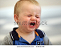 A crying one year old baby boy - stock photo