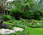 Photo of a mid-sized tropical full sun backyard concrete paver landscaping in Miami for summer.