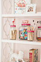 Mason jars with painted lids topped with toy animals hold craft supplies.<br/>
