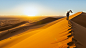 andreaobzerova在 500px 上的照片Traveler in the desert, active young woman trekking in hot sandy wilderness, dramatic sunset, summer