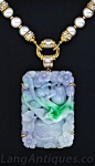 Carved Natural Lavender and Green Jade, Pearl and Diamond Necklace. This opulent and exotic pendant necklace from the 1980s features a thick and substantial carved jadeite plaque, measuring 2 3/8 by 1 5/8 inches, which graduates in color from pale green t