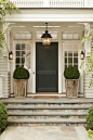 charcoal door, transoms, lantern, oversize corbels, potted boxwoods, slate...perfection!