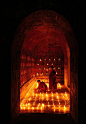 young monks lighting candles