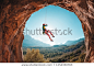 The climber is hanging on a rope. The girl goes down. Rock climbing in Turkey. Mountain landscape. A woman is engaged in extreme sports. Rock in the form of an arch. Climbing route in the cave.