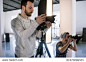 Creative photographers work in studio. Two people with cameras during the studio session. Creative photo and video team shooting in interior