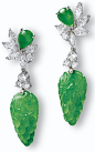 Jadeite and diamond earrings. Each suspending on a translucent jadeite of intense apple green colour carved to the front and back with grapes and bat motifs, surmounted by a pear-shaped jadeite cabochon of matching colour and translucency,decorated with m