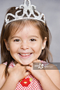 Close up portrait of young girl wearing princess crown