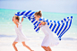 Little girls having fun running with towels on tropical beach with white sand and turquoise ocean... by Dmitry Travnikov on 500px