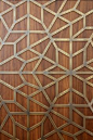 Detailed metal fret work laid over wood
