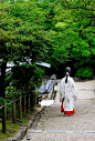 A miko (巫女), Shinto shrine maiden.