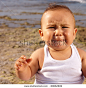 angry baby in the beach closeup - stock photo