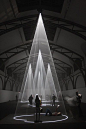 The light and sound installation Five Minutes Of Pure Sculpture by British artist Anthony McCall Visitors at the Hamburger Bahnhof museum: