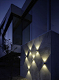 We love this clever use of multiple outdoor wall lights to create a textured feature of layered light.