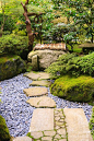 Stone walkway  with river stones leads to well in Portland Japanese Garden strolling garden.  Lantern seen in background amoung trees and rhododendrons and azaleas.: 