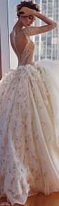 Gorgeous wedding dress with a sheer lace bodice and sleeves and full floral skirt: