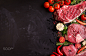 Raw meat steaks on a dark background ready to roasting by Elena Eryomenko on 500px