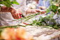 Florist trimming flower stems at flower shop by Caia Images on 500px