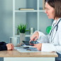 Female doctor presenting medical exam results to patient using t