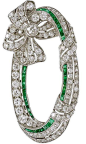 Art Deco Emerald Diamond Platinum Ribbon Brooch. A striking Art Deco Emerald and Diamond Platinum Oval Ribbon Brooch. This Art Deco Brooch has 105 Old mine cut Diamonds of H-I color VS/SI with a total weight of 5.75cts with 44 caliber-cut Emeralds approxi