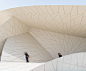 National Museum of Qatar — Ateliers Jean Nouvel : Architectural and Museographical Design: The Desert Rose   The National Museum of Qatar emerges from a desert that has ventured all the way to the sea. On the site, the Royal Palace of Sheikh Abdullah bin 