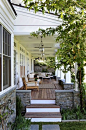 Love the low stone wall around this porch. And the wood. And the space. And the porch.