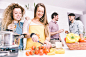 Group of friends cooking at home to have dinner together