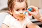 little girl feeding from a spoon on blue chair. by Vitalii Mohylenets on 500px