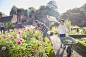 Father and son gardening in sunny flower garden by Caia Images on 500px