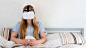 Beautiful woman using VR headset in bed