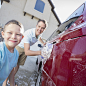 Caucasian family washing car in driveway : Caucasian family washing car in driveway